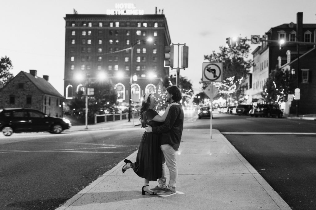 Couple posing in the middle of a street at night