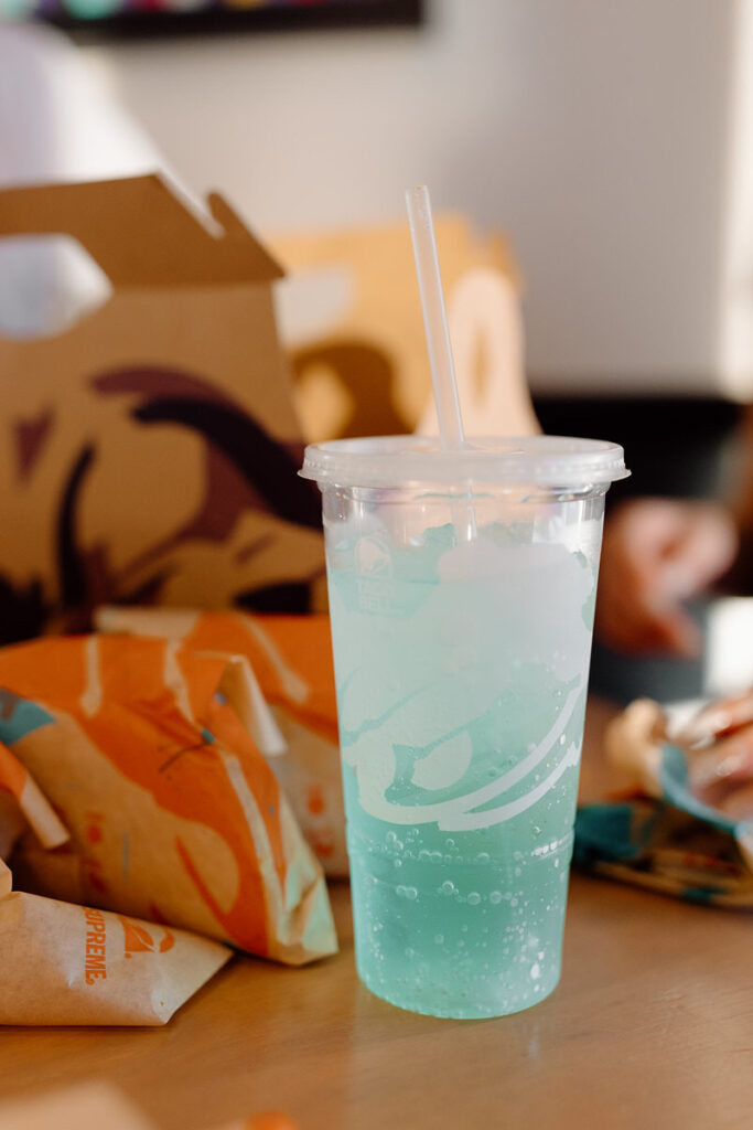 A baja blast with wrapped tacos behind it. 