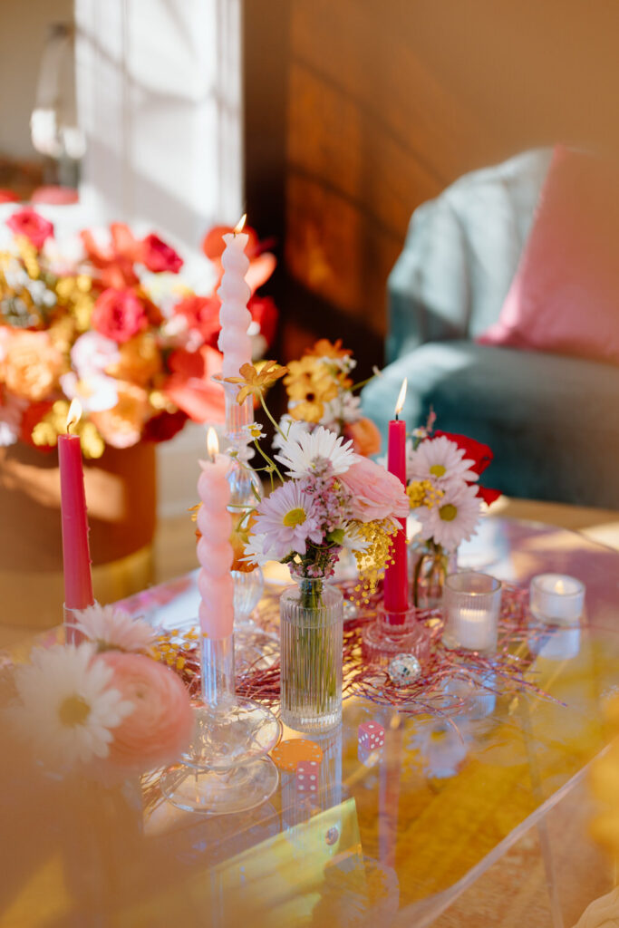Close up of flowers and candles on a table.