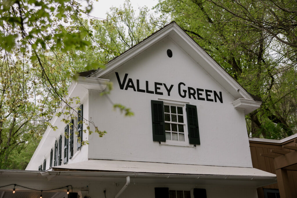 Exterior of a white building that says Valley Green.