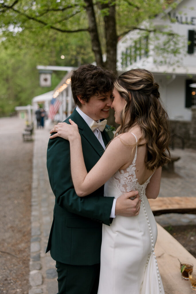 A couple on their wedding day holds one another close.