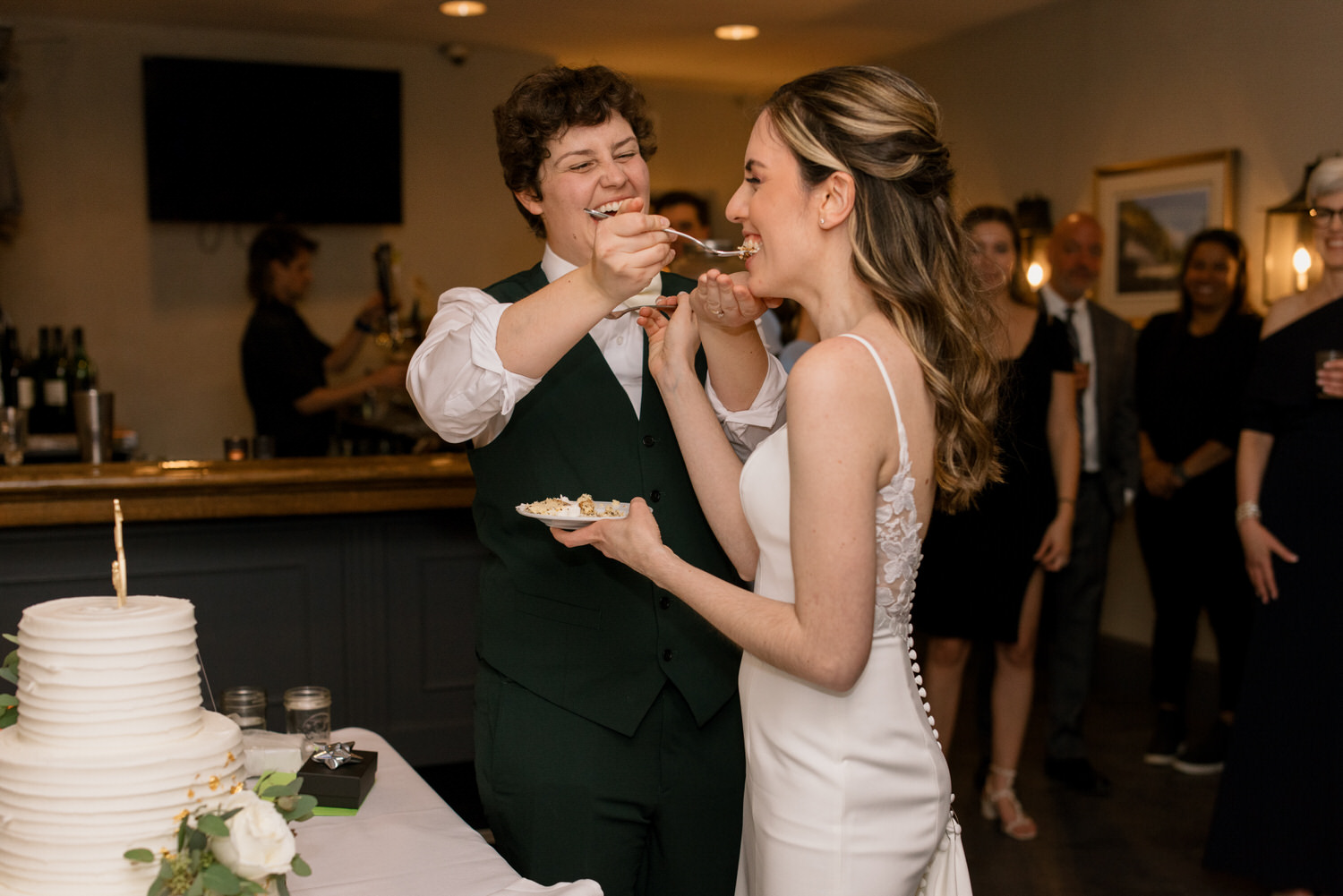 A couple feeding cake to one another at a Valley Green Inn wedding.